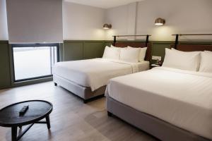 Postel nebo postele na pokoji v ubytování Monocolo Boutique Hotel