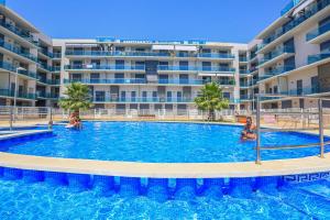 a swimming pool in front of a large apartment building at Augusta Litoral - ONLY FAMILIES in Cambrils