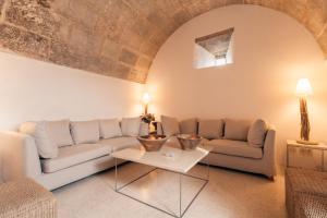 a living room with a couch and a table at Cases de Son Barbassa Hotel & Restaurant in Capdepera