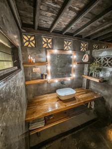 a bathroom with a sink on a wooden counter at shakabrah beach club cottage in General Luna