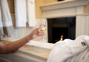 a person holding up a glass of wine at Wentworth Mansion in Charleston
