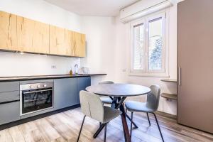 a kitchen with a table and chairs in a room at Ticinello 1 in Milan +15 photos