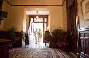 a bride and groom walking down a hallway at Wentworth Mansion in Charleston