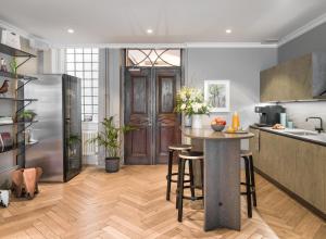 a kitchen with a stainless steel refrigerator and a table at The Hamlet in Geneva