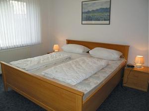 a bedroom with a large bed with two pillows at Maike 5a in Cuxhaven
