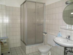 a bathroom with a shower and a toilet and a sink at Maike 5a in Cuxhaven