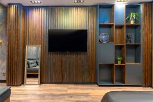 a living room with a television on a wooden wall at 6 Apartment Galata in Istanbul