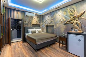 a bedroom with a bed and a wall with a painting at 6 Apartment Galata in Istanbul