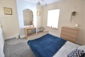 a bedroom with a large mirror and a blue rug at Church View in Quorndon