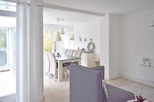 a kitchen and dining room with a table and chairs at Strandlaeufer in Cuxhaven