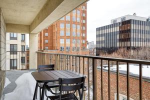 a balcony with a table and chairs on a building at Central Sq 2BR nr Central Sq T stop BOS-570 in Cambridge