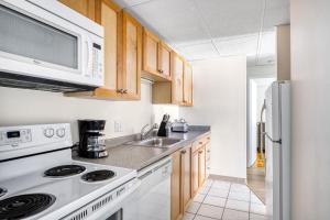 a kitchen with a stove and a microwave at Central Sq 2BR nr Central Sq T stop BOS-570 in Cambridge +14 photos