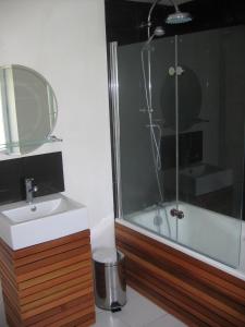 a bathroom with a sink and a shower at The Heart of Sainte Mere Eglise in Sainte-Mère-Église