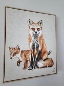 a painting of two foxes and a kitten at Jersey Cottage in Horseheath