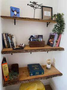 a shelf with books and other items on it at ARDUTHIE STREET in Stonehaven