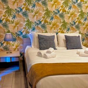 a bedroom with a large bed with a tropical wallpaper at B&B Bovio Square XIV in Naples