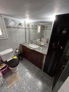 a bathroom with a sink and a toilet and a mirror at Skytrack SA in Thessaloniki