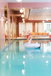 a pool with a swan float in the water at Mama Shelter Rennes in Rennes