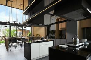 una cocina con electrodomésticos en blanco y negro y una mesa en Srinakarin Lasalle 2 BR Bangkok, en Bangna