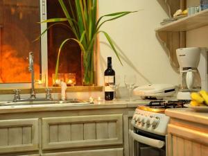 a kitchen with a sink and a stove and a counter top at apartmán Roatan A24 Czech Village in Arrozal