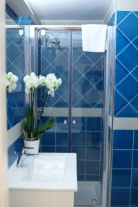 a bathroom with a sink and a glass shower at NANNI LOFT HOUSE in Castellammare di Stabia +54 photos