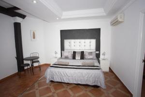 a bedroom with a large bed and a table at Alojamiento el Chaparro Barbate junto a la venta el loro in Barbate +68 photos