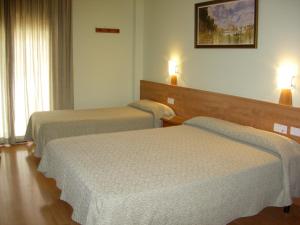 Postel nebo postele na pokoji v ubytování Hotel Flora Parc