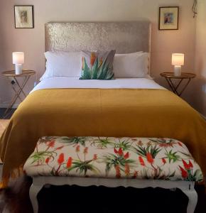 a bedroom with a bed with a plant on it at Aloe Valley Retreat in Oudtshoorn