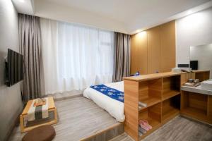 a hotel room with a bed and a sink at 武陵山水客栈Wuling Shanshui Hotel in Zhangjiajie