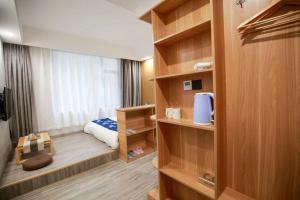 a room with a bedroom with a bed and shelves at 武陵山水客栈Wuling Shanshui Hotel in Zhangjiajie