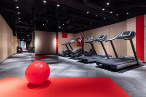 a gym with a red ball in the middle of a room at Courtyard by Marriott Shin-Osaka Station in Osaka
