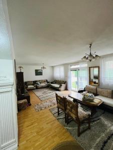 a living room with a table and a couch at Apartmani Lukare in Novi Pazar