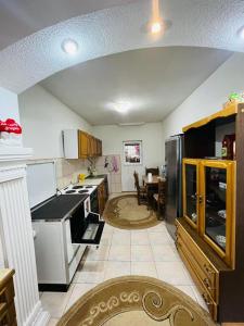 a large kitchen with a stove and a refrigerator at Apartmani Lukare in Novi Pazar