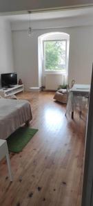 a living room with a bed and a window at Autrefois la Cure in Bonnefontaine