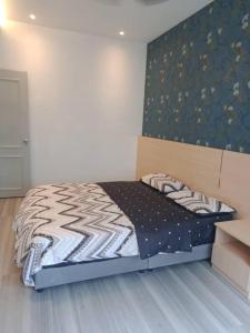 a bedroom with a large bed with a headboard at Muslim Homestay blue Adik Aisyah Apartment in Tanah Rata