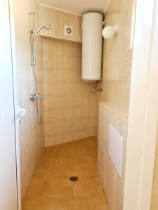 a bathroom with a shower and a tiled floor at Boat & Night keep cool in Sarafovo