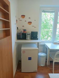 a kitchen with a table and a microwave on a wall at Oldie Apartment Šamorín in Šamorín