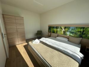 a bedroom with a large bed with a large window at Boarding Apartments Paderborn in Paderborn