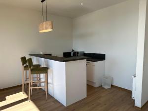 a kitchen with a counter and stools in a room at Boarding Apartments Paderborn in Paderborn