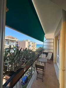 a balcony with a table and chairs and a view of the ocean at ALLOGGIO VISTA MARE LOANO in Loano