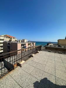 a view of the beach from the balcony of a building at ALLOGGIO VISTA MARE LOANO in Loano
