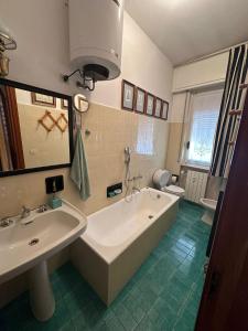 a bathroom with a tub and a sink and a toilet at ALLOGGIO VISTA MARE LOANO in Loano