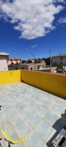 a view of a rooftop with a yellow wall at Casa Orosei Mannu in Orosei