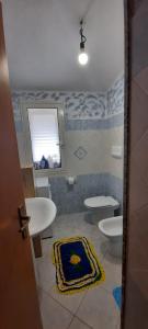 a bathroom with two toilets and a sink at Casa Orosei Mannu in Orosei