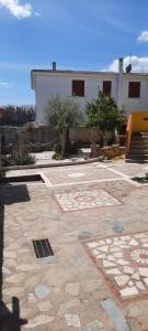 a stone courtyard with a building in the background at Casa Orosei Mannu in Orosei