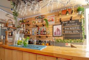 a bar in a restaurant with a counter with plants at Molesworth Arms in Wadebridge
