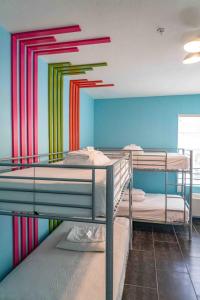 a room with two bunk beds with colorful walls at Beds n' Drinks in Miami Beach