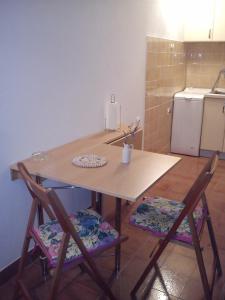 a kitchen with a wooden table and two chairs at Apartment Gabre Trogir in Trogir