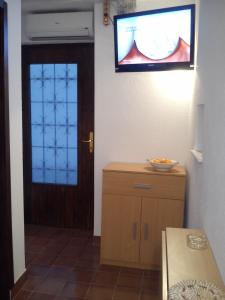 a room with a door and a television on the wall at Apartment Gabre Trogir in Trogir