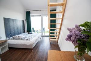 a bedroom with a bunk bed and a ladder at Forrest Jantar in Jantar